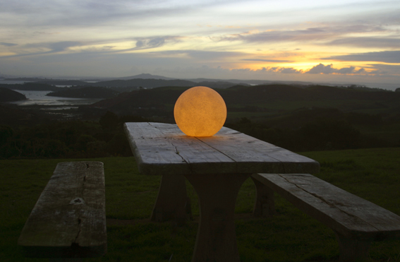 sphere stone garden light on table lit